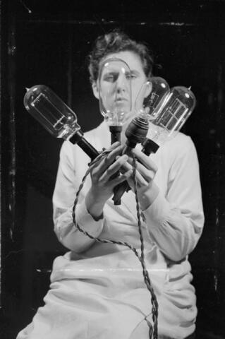 National Physical Laboratory- Science and Technology in Wartime, Teddington, Middlesex, England, UK, 1944 In the Photometry Section of the Light Division at the National Physical Laboratory, a technician examines a selection of electric light bulbs which are used as standards in various photometric tests. National Physical Laboratory- Science and Technology in Wartime, Teddington, Middlesex, England, UK, 1944 In the Photometry Section of the Light Division at the National Physical Laboratory, a technician examines a selection of electric light bulbs which are used as standards in various photometric tests.